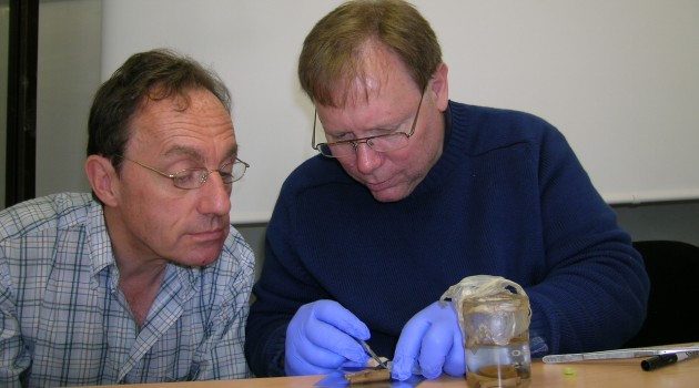 Alain Touwaide and Robert Fleischer examine a phial recovered from the wreckage.