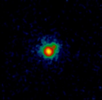 The dim glow of the binary brown dwarf system CFBDSIR 1458+10, as seen in the H-band (1.6 microns) by the Keck II Telescope’s powerful Laser Guide Star Adaptive Optics system. Field of view is 1.5 x 1.1 arcseconds. CFBDSIR 1458+10B is the smaller, cooler partner of the pair. Credit: Michael Liu, et. al/ W.M. Keck Observatory