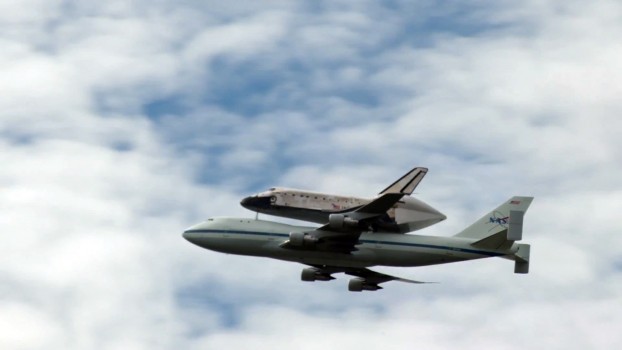 Space Shuttle Discovery atop a 747 flying over the National Mall in Washington, D.C.