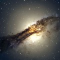The giant elliptical galaxy Centaurus A shows a split personality because it hides a gaseous spiral at its core. When Centaurus A collided with a spiral galaxy 300 million years ago, it slurped up the spiral's gases, which formed a new spiral inside the larger galaxy. Credit: ESO