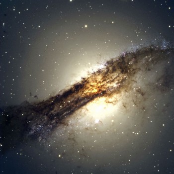 The giant elliptical galaxy Centaurus A shows a split personality because it hides a gaseous spiral at its core. When Centaurus A collided with a spiral galaxy 300 million years ago, it slurped up the spiral's gases, which formed a new spiral inside the larger galaxy. Credit: ESO