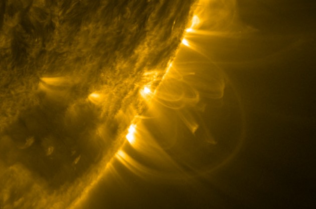 This photo of the Sun's edge, taken with the Solar Dynamics Observatory Atmospheric Imaging Assembly, shows coronal loops in a variety of sizes. Although the loops appear to have a constant width, like strands of rope, new work suggests that this is an optical illusion. The loops are actually tapered, wider at the top and narrower at the bottom. (Photo credit: NASA/SDO)