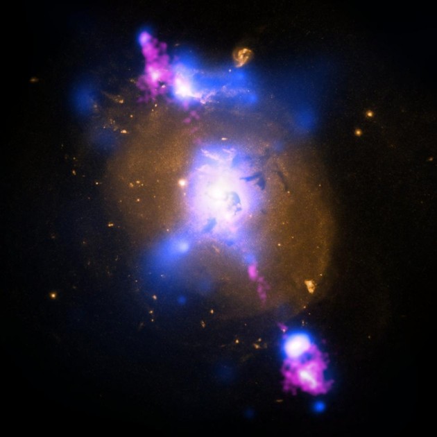 This composite image of a galaxy illustrates how the intense gravity of a supermassive black hole can be tapped to generate immense power. The image contains X-ray data from NASA's Chandra X-ray Observatory (blue), optical light obtained with the Hubble Space Telescope (gold) and radio waves from the NSF's Very Large Array (pink). (Image courtesy NASA)
