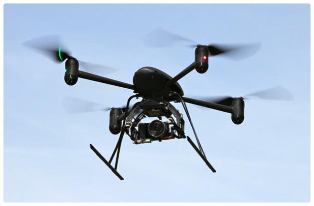 A Draganflyer X4 quadcopter carrying a camera.