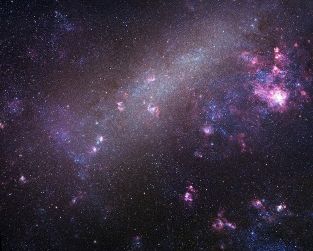 Astronomers have identified 18 extreme mass-ratio binaries in a neighboring galaxy called the Large Magellanic Cloud, pictured here. The more massive stars weigh 6 to 16 times as much as the Sun, while the less massive stars weigh about 1 to 2 times the Sun. We've caught them "in the delivery room," since one star is fully formed while the other is still in its infancy. These systems represent a new class of binary stars. (Image copyright Robert Gendler and Josch Hambsch 2005)