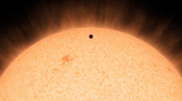 This artist's conception shows the silhouette of a rocky planet, dubbed HD 219134b, as it passes in front of its star. At 21 light-years away, the planet is the closest outside of our solar system that crosses, or transits, its star -- a bonus for astronomers because transiting planets are easier to study. The planet, which is about 1.6 times the size of Earth, is also the nearest confirmed rocky planet outside our solar system. It orbits a star that is cooler and smaller than our sun, whipping snuggly around it in a mere 3 days. The proximity of the planet to the star means that it would be scorching hot and not habitable. (Image courtesy NASA/JPL-Caltech)
