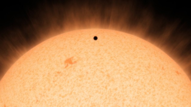  This artist's conception shows the silhouette of a rocky planet, dubbed HD 219134b, as it passes in front of its star. At 21 light-years away, the planet is the closest outside of our solar system that crosses, or transits, its star -- a bonus for astronomers because transiting planets are easier to study. The planet, which is about 1.6 times the size of Earth, is also the nearest confirmed rocky planet outside our solar system. It orbits a star that is cooler and smaller than our sun, whipping snuggly around it in a mere 3 days. The proximity of the planet to the star means that it would be scorching hot and not habitable. (Image courtesy NASA/JPL-Caltech) 