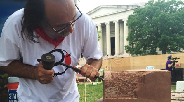 Master stone carver Bernat Vidal, from the Basque Country in northern Spain and southern France, chisels a piece of Seneca sandstone during the 2016 Smithsonian Folklife Festival in Washington, D.C. Vidal is making a rough replica of a corbel from the Smithsonian Castle. (Photo by Michelle Z. Donahue)
