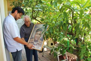 Two men looking at framed poster