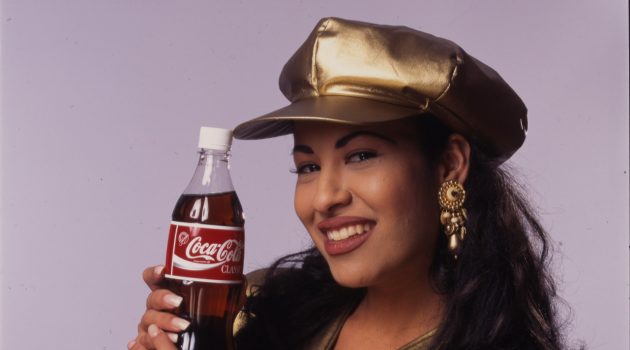 Selena in gold lamé top with matching hat, 1994. 
Photo by Al Rendon, Collection of the Smithsonian’s National Museum of American History